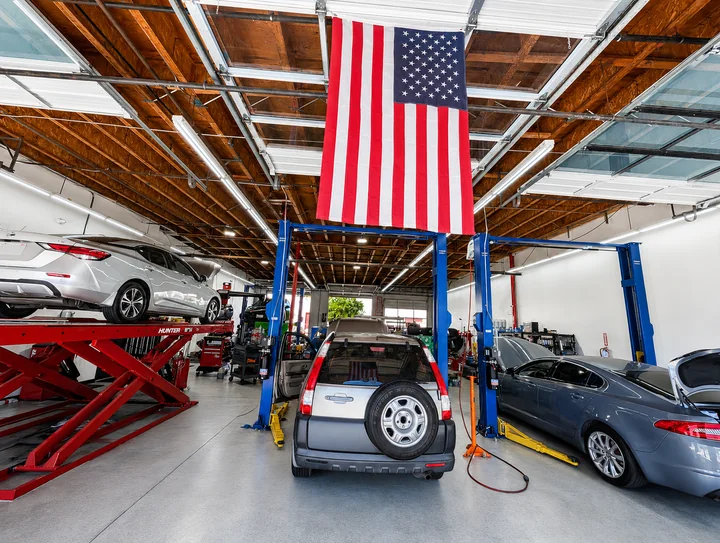 The service floor at Super Service of Corona Hills with vehicles on lifts